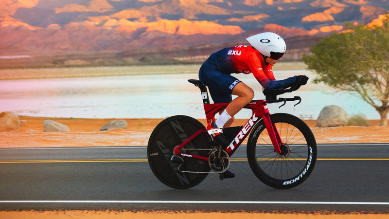 cyclist riding a tt/triathalon bike down a gravel path