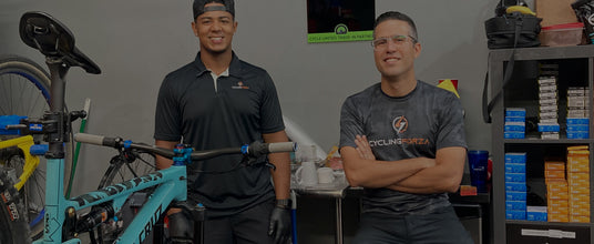two cycle limited employees posing in the bike shop