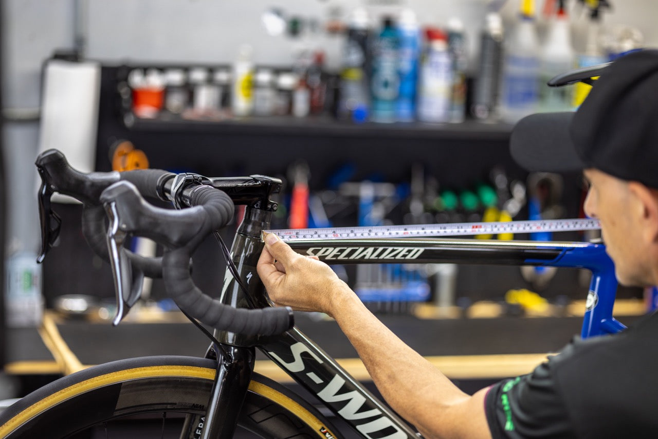 cycle limited employee measuring the frame on a bicycle