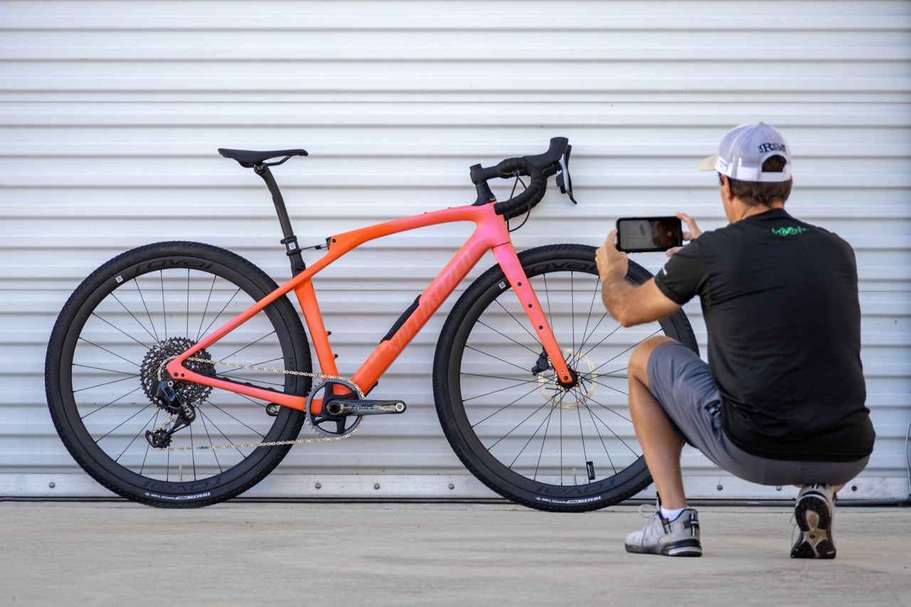 person taking a photograph with their phone of a bicycle they're going to list for sale