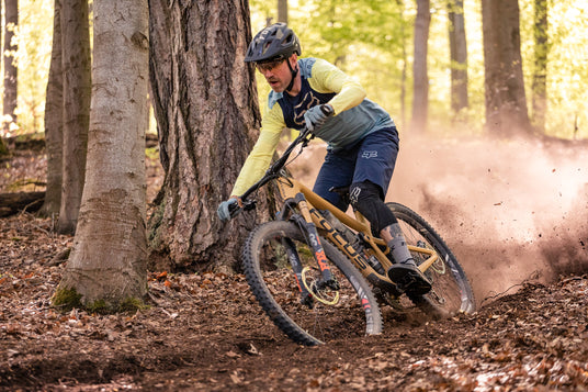 cyclist riding a mountain bike down a mountain trail