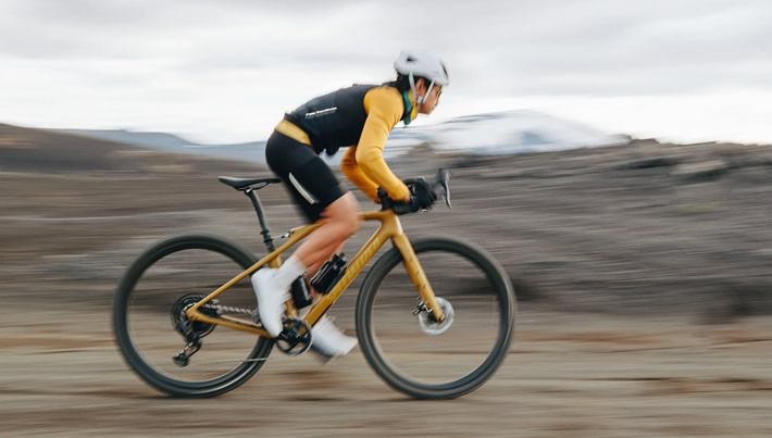 cyclist riding gravel bike on mountain trail